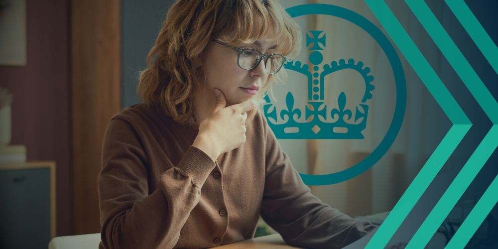 Image of female professional reading business documents with HMRC logo superimposed, representing article on compliance scrutiny recruiters face from HMRC