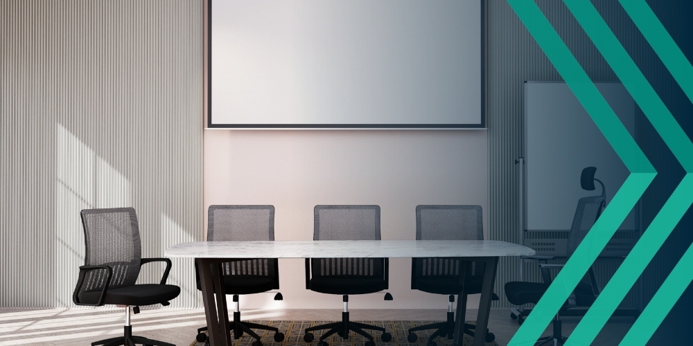 Image of empty white meeting room with table and office chairs. Representing article on what management liability is for recruiters