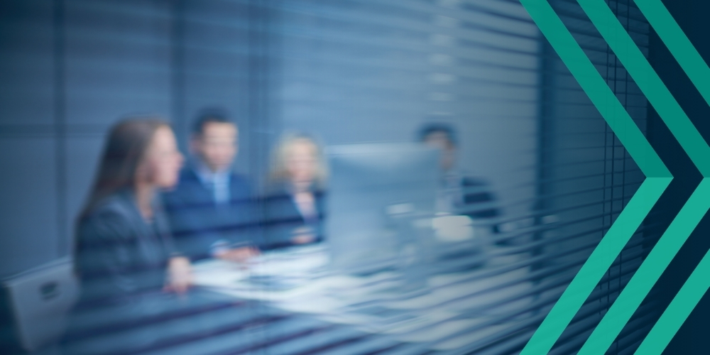 Photo of office meeting behind blinds, implying hidden risks for recruitment of contractor liability