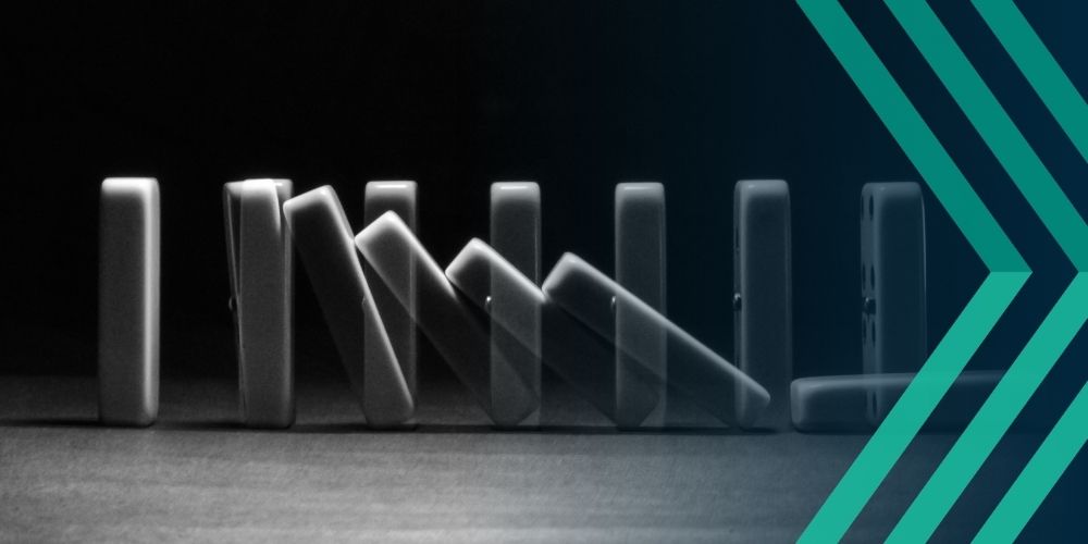 Black and white image of dominoes falling, representing article on the domino effect 6 recruiter risks can have